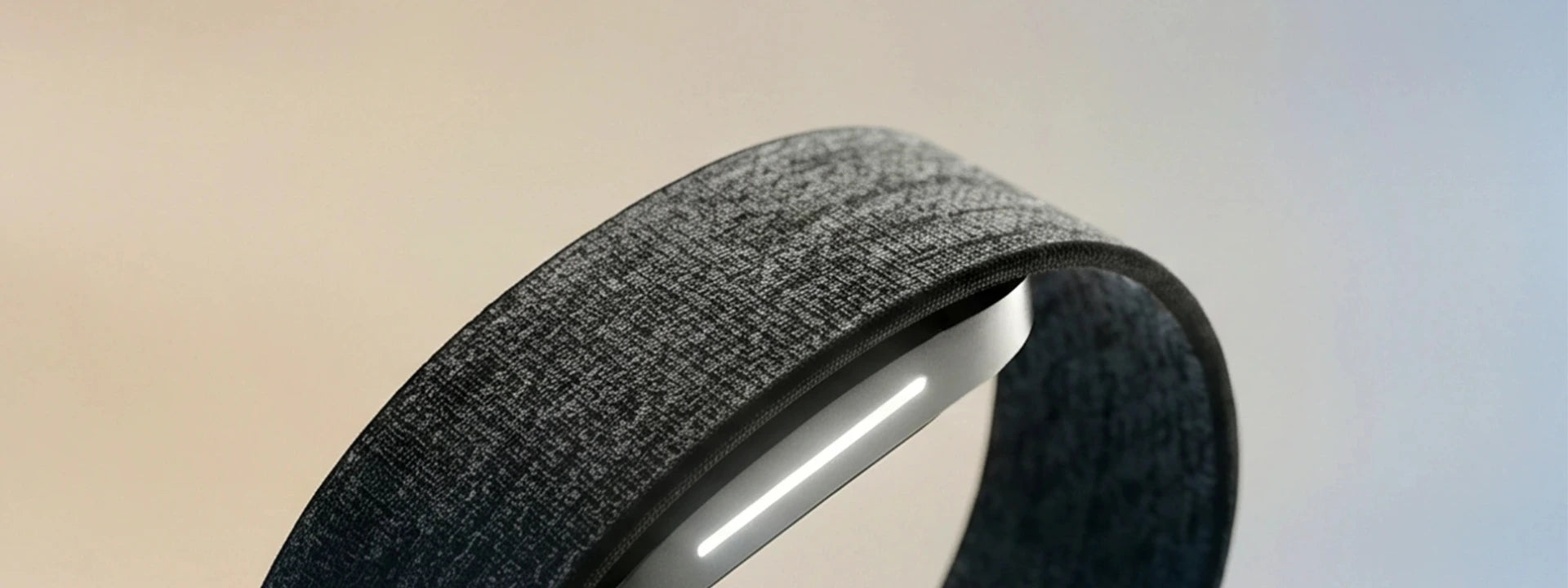 The four wearables laid out side by side on a desk